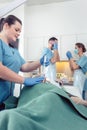 Nurse giving anesthesia to patient waiting for endoscopy