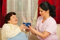 Nurse giving bowl with soup to senior