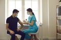 Nurse giving flu shot to young patient during vaccination campaign at the hospital Royalty Free Stock Photo