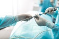 Nurse giving laparoscope to doctor during surgery