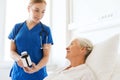 Nurse giving medicine to senior woman at hospital Royalty Free Stock Photo