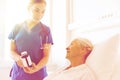 Nurse giving medicine to senior woman at hospital Royalty Free Stock Photo