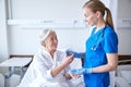 Nurse giving medicine to senior woman at hospital Royalty Free Stock Photo