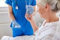 Nurse giving medicine to senior woman at hospital Royalty Free Stock Photo