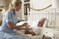 Nurse Giving Senior Male Medication In Bed At Home Royalty Free Stock Photo