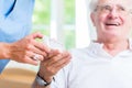 Nurse giving senior man prescription drugs Royalty Free Stock Photo