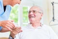 Nurse giving senior man prescription drugs Royalty Free Stock Photo