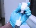 Nurse in gloves preparing solution of white drugs