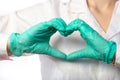 Nurse in gloves showing heart gesture, close up