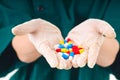 Nurse hands with gloves and pills