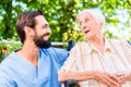 Nurse having chat with senior woman in nursing home Royalty Free Stock Photo