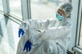 Nurse having headache and tired from work while wearing PPE suit for protect coronavirus disease. The wellbeing and emotional Royalty Free Stock Photo