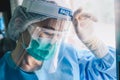 Nurse having headache and tired from work while wearing PPE suit for protect coronavirus disease. Royalty Free Stock Photo