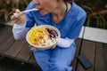 Nurse having healthy lunch in front of hospital building, taking break from work. Importance of breaks in healthcare. Royalty Free Stock Photo
