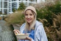 Nurse having healthy lunch, snack in front of hospital building, taking break from work. Importance of breaks in Royalty Free Stock Photo