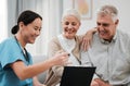 Nurse, healthcare and support with a senior couple in their home, talking to a medicine professional. Medical, insurance Royalty Free Stock Photo