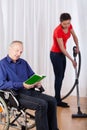Nurse helping disabled with cleaning