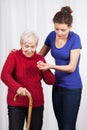 Nurse helping elderly lady walk