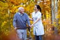 Nurse helping elderly senior man.