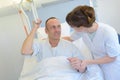Nurse helping patient lift from bed Royalty Free Stock Photo