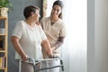 Nurse helping senior to walk