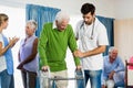 Nurse helping senior with walking aid Royalty Free Stock Photo