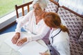 Nurse helping senior woman with braille Royalty Free Stock Photo