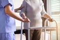 Nurse helping senior woman hand holding walker trying to walk,Care nursing home concept Royalty Free Stock Photo