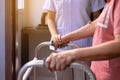 Nurse helping senior woman hand holding walker trying to walk,Care nursing home concept Royalty Free Stock Photo