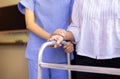 Nurse helping senior woman hand holding walker trying to walk,Care nursing home concept Royalty Free Stock Photo