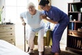 Nurse helping senior woman to stand Royalty Free Stock Photo