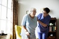 Nurse helping senior woman to stand