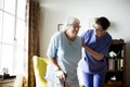 Nurse helping senior woman to stand Royalty Free Stock Photo