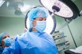 Nurse helping a surgeon in wearing scrub Royalty Free Stock Photo