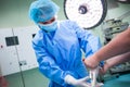 Nurse helping a surgeon in wearing surgical gloves Royalty Free Stock Photo