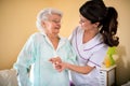 Helps old senior woman to walk with help of crutches Royalty Free Stock Photo