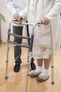 The nurse helps the old woman to walk with rehabilitation walker Royalty Free Stock Photo