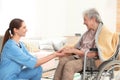 Nurse holding elderly woman`s hands. Assisting senior people Royalty Free Stock Photo