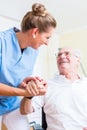 Nurse holding hand of senior man in rest home Royalty Free Stock Photo