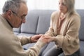 Nurse holding hand of senior man in rest home Royalty Free Stock Photo