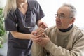 Nurse holding hand of senior man in rest home. Royalty Free Stock Photo