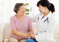 Nurse holding hand of senior woman in rest home Royalty Free Stock Photo