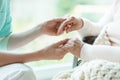 Nurse holding patient`s hands