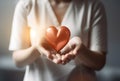 A nurse holding a red heart