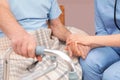 Nurse holding senior patient`s hand in hospital, closeup. Royalty Free Stock Photo