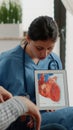 Nurse holding tablet with heart figure for cardiology diagnosis Royalty Free Stock Photo