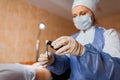 Nurse holds in hands tweezers and drips an antibacterial solution on cotton wool of brilliant green alcohol on cotton wool. Royalty Free Stock Photo