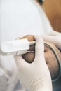 Nurse holds patient`s hand with an attached pulse oximeter as a symbol of compassion