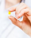 Nurse holds pilule in finger