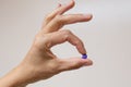 The nurse holds purple tablets in her fingers to indicate plaque